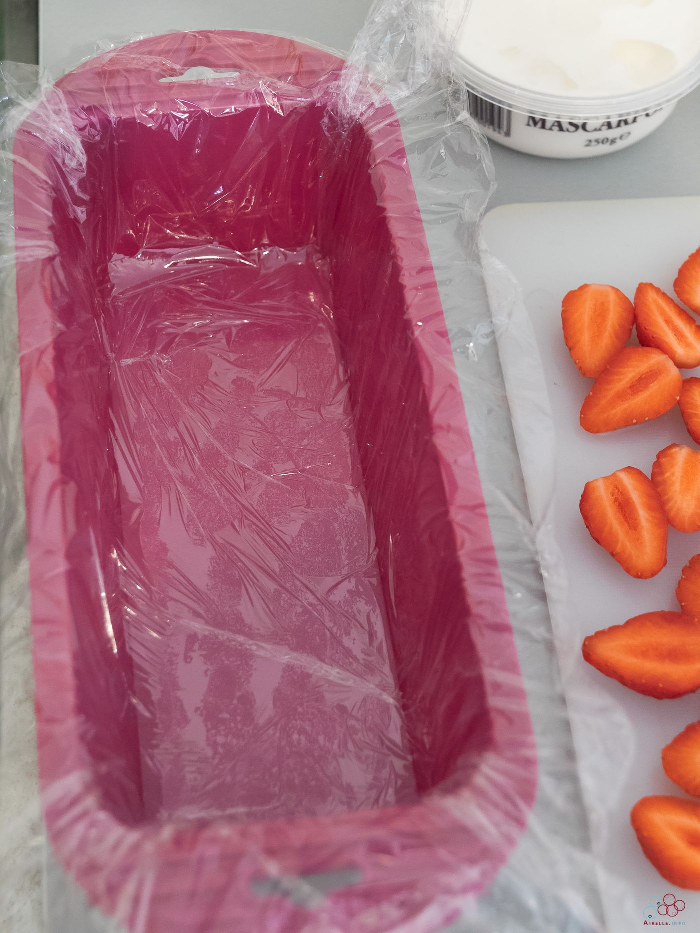 Photo of a silicone cake mold whose base is covered with cling film.